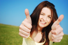 photos shows a job seeker with a big positive smile on her face giving a double thumbs up after heeding this careers advice